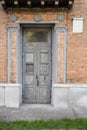 Antique doors of the main entrance to the house, with molding on the facade Royalty Free Stock Photo