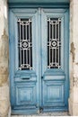 antique, double-leaf, blue entrance door with decor and glass