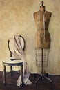 Antique dress form and chair with vintage feeling Royalty Free Stock Photo