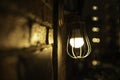 Antique electronic lamp, hanging at the red brick wall in the building.soft focus