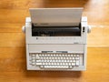 Antique electronic typewriter on a wood desk