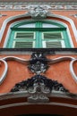 Antique, elegant arched window with louvered shutters and green glass. Royalty Free Stock Photo