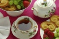 Antique elegant floral tea setting. English tea time with fruit and biscuits Royalty Free Stock Photo