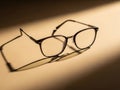 Antique eyeglasses creating striking shadow effects for promotion Royalty Free Stock Photo