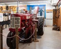 Antique farm tractor is on display in a museum exhibit room