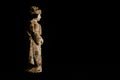 Antique figurine of a geisha in profile, black background