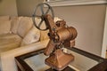 Antique Film Projector on Glass Table with Cozy Interior Background