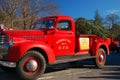 An antique fire truck with a Christmas tree