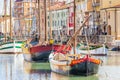 Antique fishing boats in harbor channel