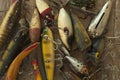 Antique fishing lures on rough wood surface viewed from above