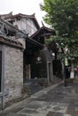 Antique flagstone road and brick house