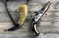 Antique Flintlock Pistol and Gunpowder Horn Royalty Free Stock Photo