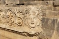 Antique frieze with stone-cut mask in the ruins of the ancient city of Myra, Turkey Royalty Free Stock Photo