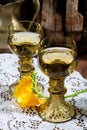 Antique German glassware, old Dutch style rummer or roemer glasses with white wine on white lace tablecloth Royalty Free Stock Photo