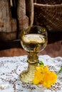 Antique German glassware, old Dutch style rummer or roemer glasses with white wine on white lace tablecloth Royalty Free Stock Photo