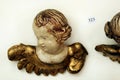 Antique carved baroque cherub angel head on wall with auction number Royalty Free Stock Photo