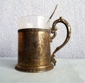 Antique gilded beautiful cup holder and spoon.