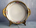 Antique gilded plate with handles.
