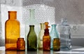 Collection of antique glass bottles on a table Royalty Free Stock Photo