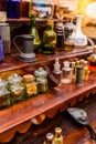 Antique glass jars with spices and perfumes on a vintage retro shelf