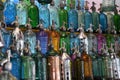 Antique glass and steel siphons of different colors at an antiques fair