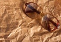 Antique glasses on old crumpled paper