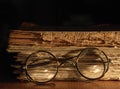 Antique glasses on old weathered book.