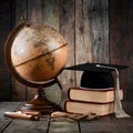 Antique globe, graduation cap, and books hint at educational travel