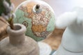 Antique globe with North America in focus sitting atop a wooden table next to a vase. Royalty Free Stock Photo