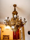 Antique gold chandelier with patterns. Royal interiors of castles.