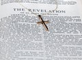 Antique gold cross on page of bible