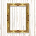 Antique gold frame on white wooden wall ;. Empty picture frame o Royalty Free Stock Photo