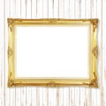 Antique gold frame on white wooden wall ;. Empty picture frame o Royalty Free Stock Photo