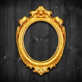 The Antique gold frame on wooden wall;. Empty Antique gold picture frame on wooden wall. Royalty Free Stock Photo