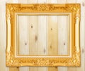 Antique gold frame on wooden wall;. Empty picture frame on woode Royalty Free Stock Photo