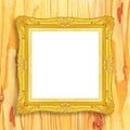 Antique gold frame on wooden wall;. Empty picture frame on wooden wall. Royalty Free Stock Photo