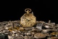 Antique gold pocket watch among clockwork parts on black isolated studio background. Gears, cogwheels, old metal Royalty Free Stock Photo