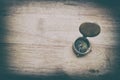 Antique golden compass on wood table. concept for direction, travel, guidance or assistance Royalty Free Stock Photo