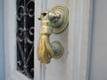 Antique golden door handle on an old wooden door Royalty Free Stock Photo