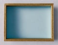 Antique golden frame on a white background, shaded blue background, Place for text or photo AI Generated