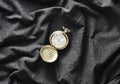 Antique golden pocket watch on a gray fabric background. Royalty Free Stock Photo