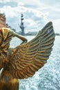 Antique golden statue angel figurehead decorative rostrum ship against the background of the Russian flag Royalty Free Stock Photo