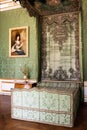 Antique green canopy bed in a stately interior