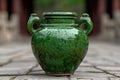 Antique green ceramic vase on wooden surface Royalty Free Stock Photo