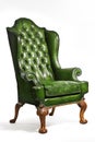 Antique green leather wing chair carved legs isolated Royalty Free Stock Photo