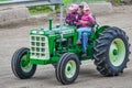 Antique Green Oliver 550 Tractor, Grandpa and Grandaughters Royalty Free Stock Photo