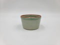 Antique green pottery Sake cup in white background for decoration and collectible Royalty Free Stock Photo