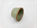 Antique green pottery Sake cup in white background for decoration and collectible