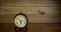 Antique hand clock on wooden table - horizontal Royalty Free Stock Photo