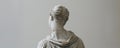 Antique headless marble sculpture of an unknown person, elegantly exhibited in a museum against a